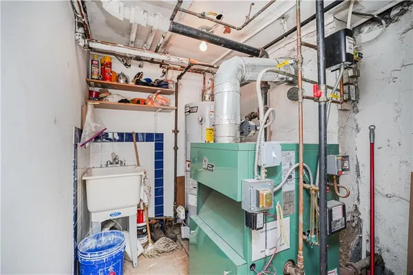 a utility room with fridge dryer and bicycles