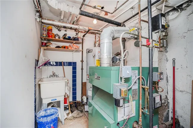 a utility room with fridge dryer and bicycles