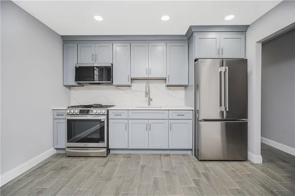 a kitchen with a refrigerator stove and microwave