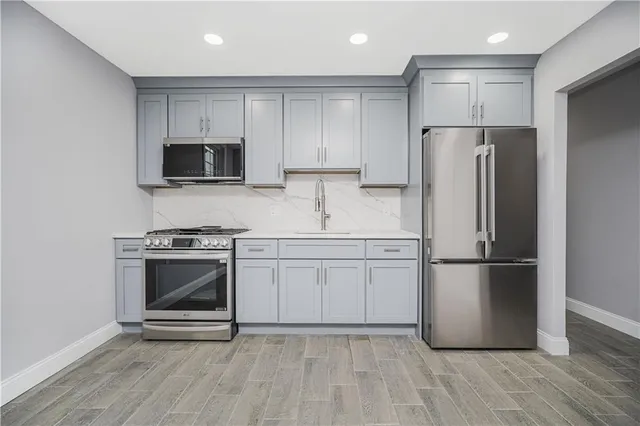 a kitchen with a refrigerator stove and microwave
