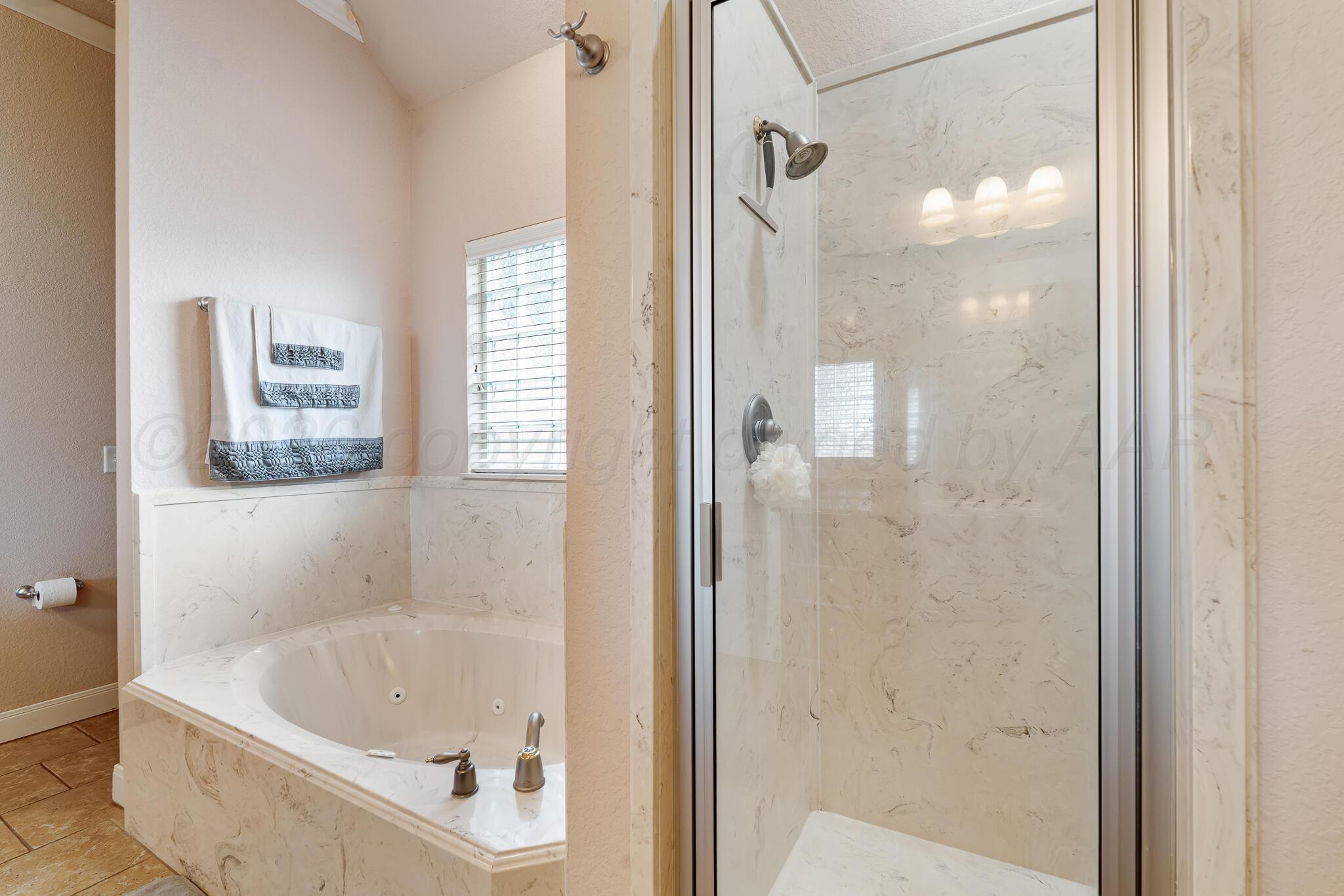5008 Wesley Road Amarillo, TX 79119 - Photo 27 of 47 a bathroom with a bathtub and shower