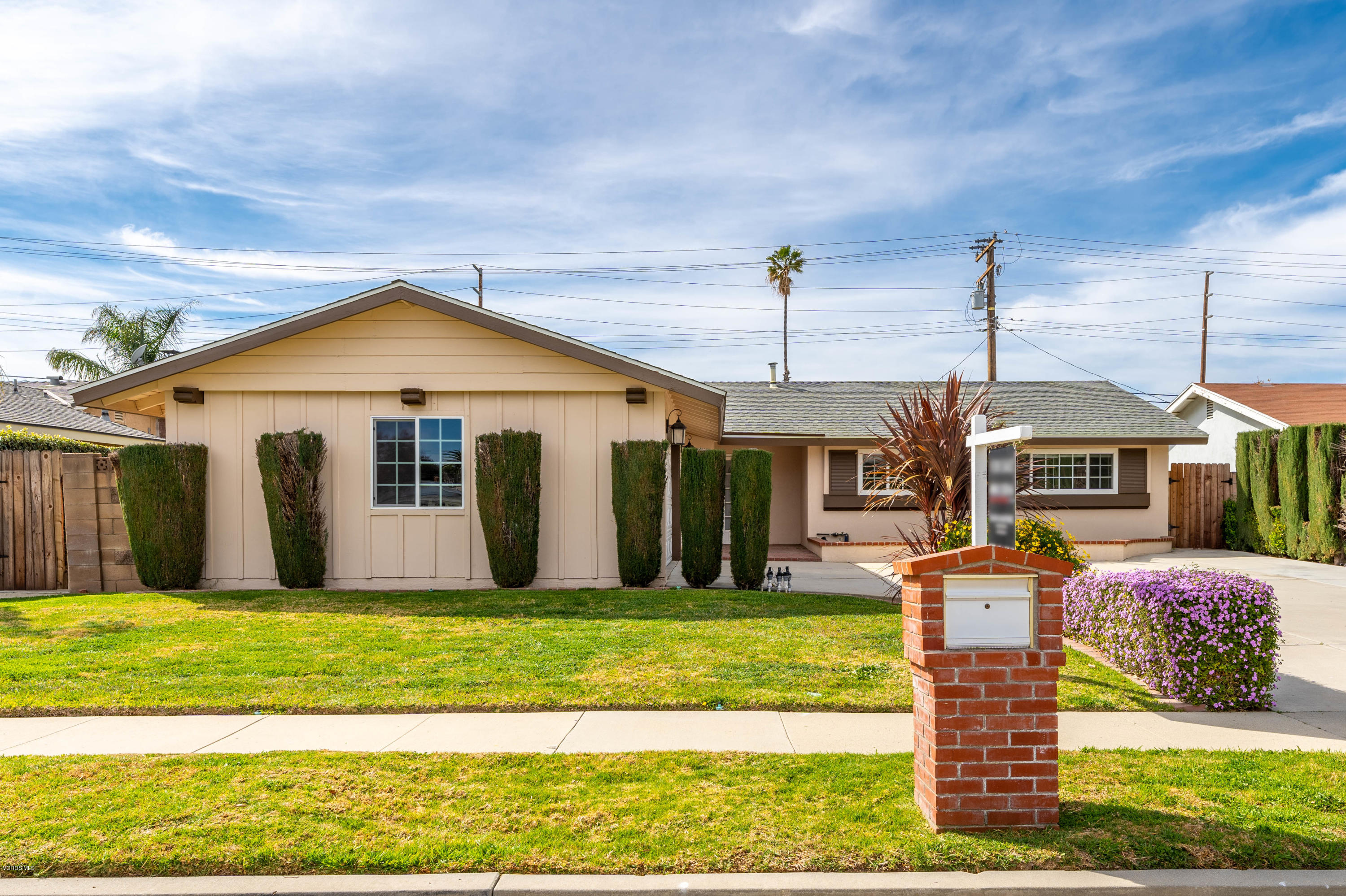 1049 Roldan Avenue Simi Valley, CA 93065 - Photo 3 of 26 a front view of a house with a yard