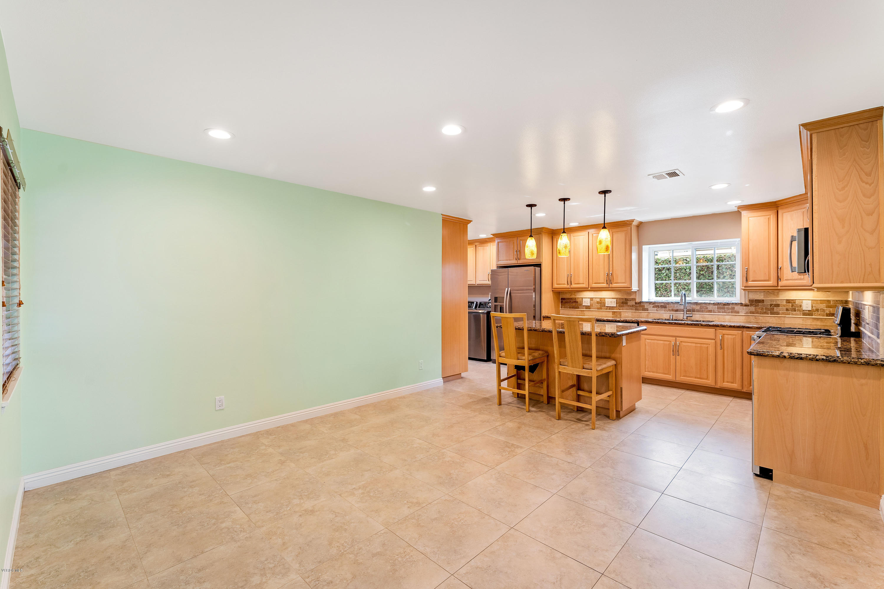 1049 Roldan Avenue Simi Valley, CA 93065 - Photo 5 of 26 a view of a kitchen with a sink and chairs