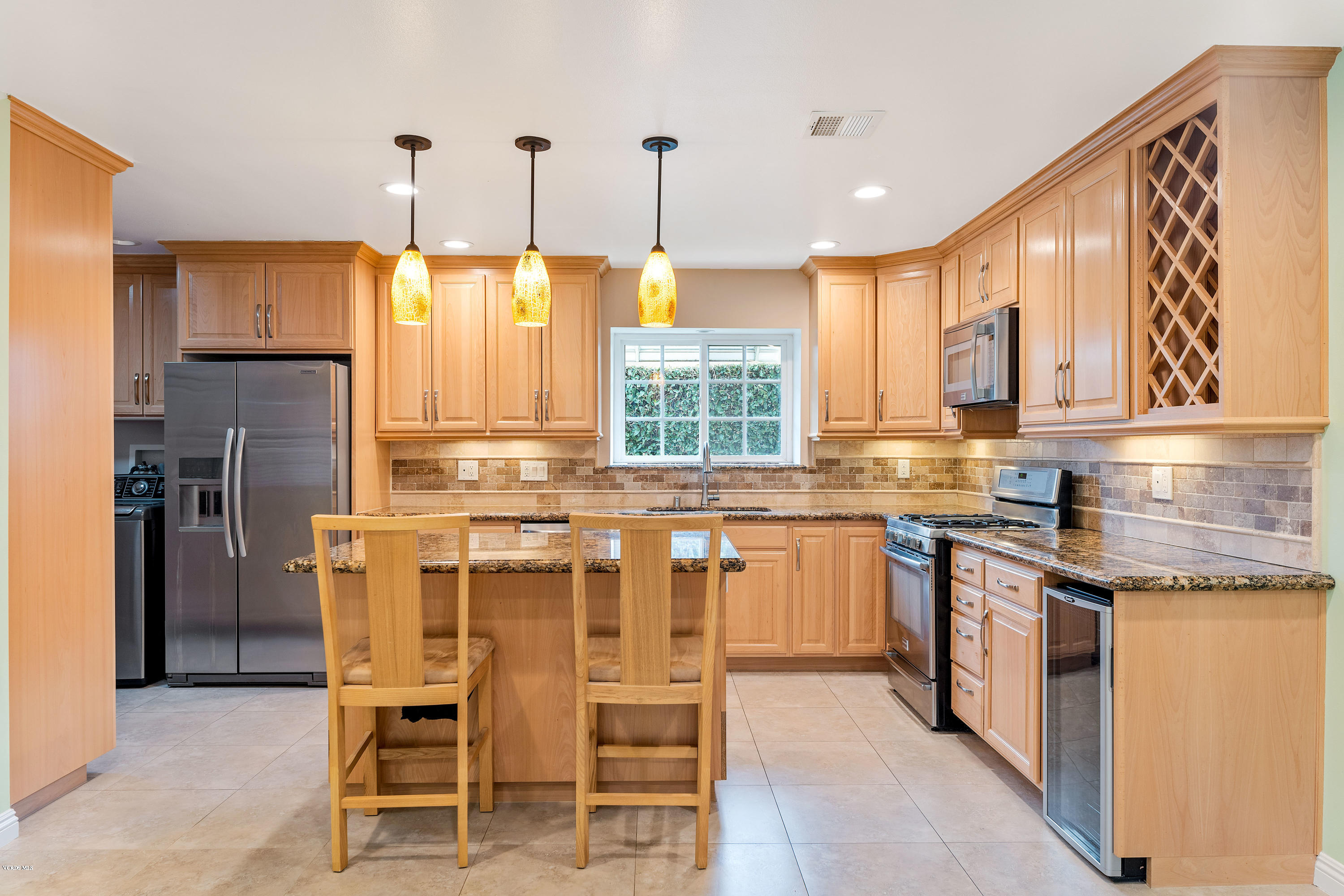 1049 Roldan Avenue Simi Valley, CA 93065 - Photo 8 of 26 a kitchen with stainless steel appliances granite countertop a stove top oven a refrigerator a sink and a dining table with wooden floor