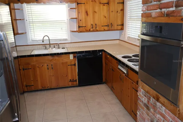 a kitchen with granite countertop cabinets and window