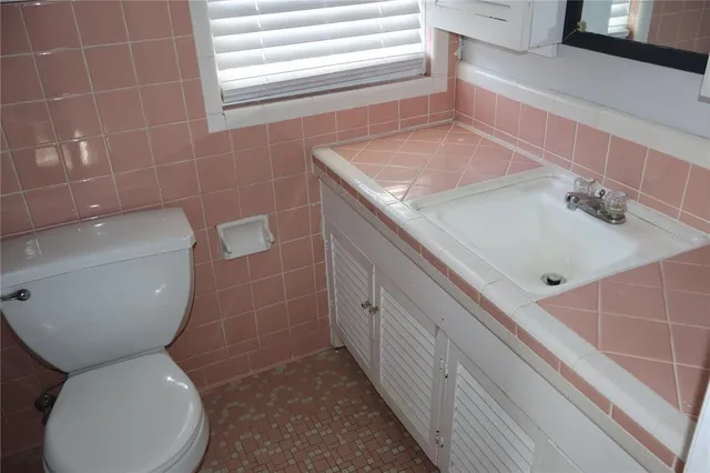 an empty room with wooden floor and windows with curtains view