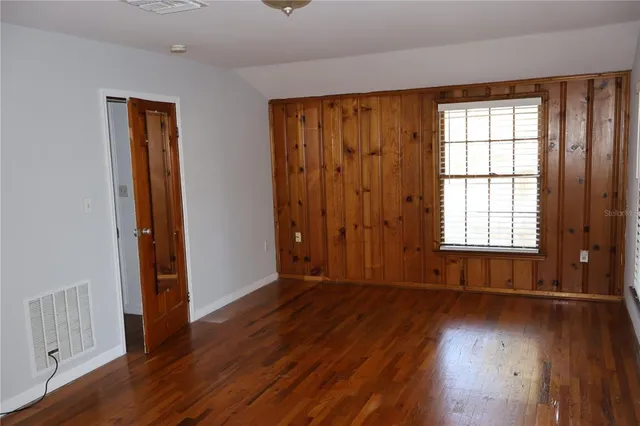 a view of a house with a tree in the yard