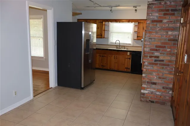 a kitchen with stainless steel appliances a refrigerator and a sink