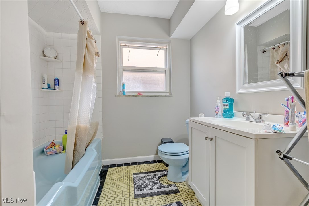 6136 Ridge Road Cleveland, OH 44129 - Photo 13 of 40 Full bathroom with vanity, tile patterned flooring, and shower / tub combo