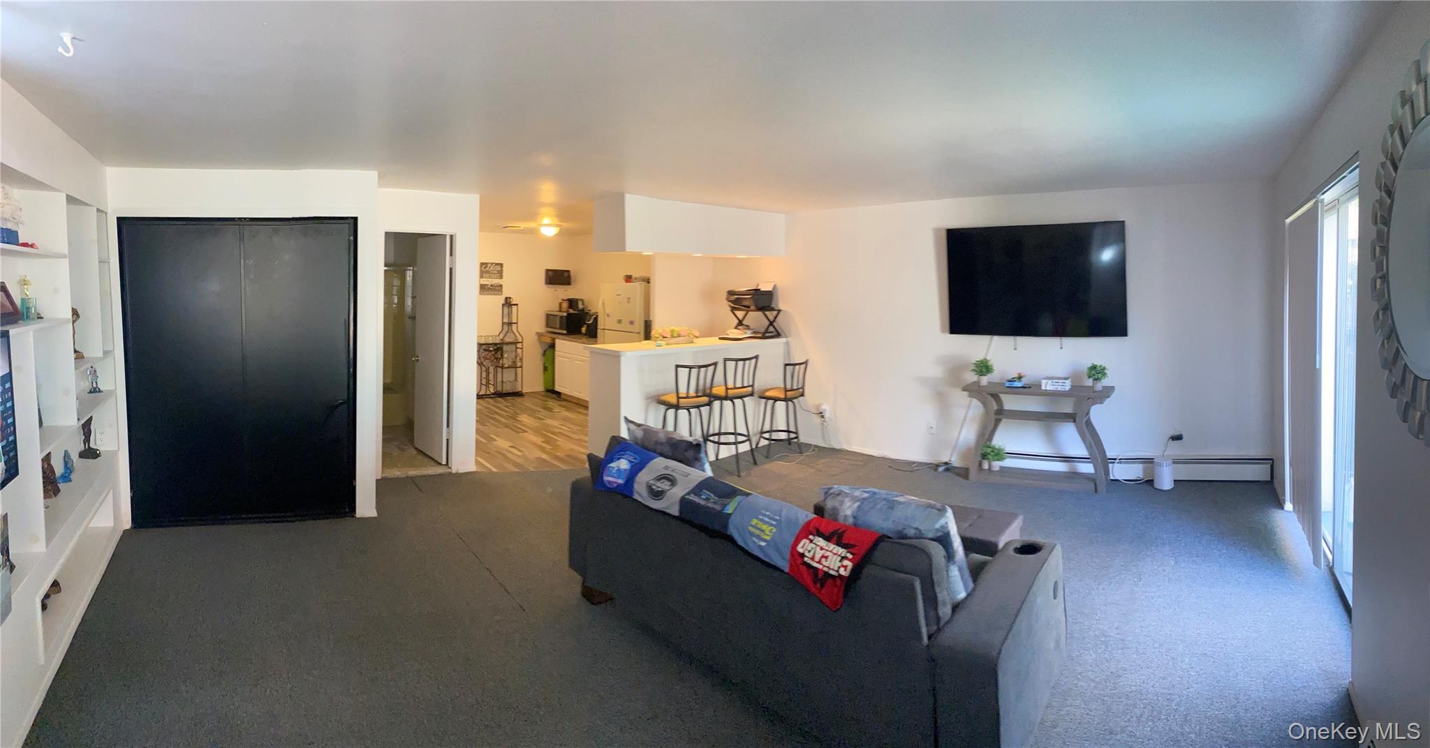 84-24 98th Street, Unit 1 Queens, NY 11421 - Photo 15 of 22 a living room with furniture and a flat screen tv