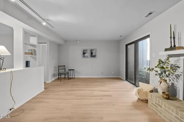 a view of a hallway with workspace and a window