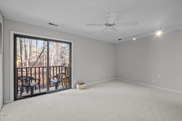 a kitchen with stainless steel appliances a refrigerator and wooden floor