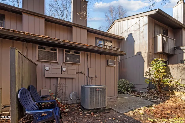 a view of a house with a door and wooden bench