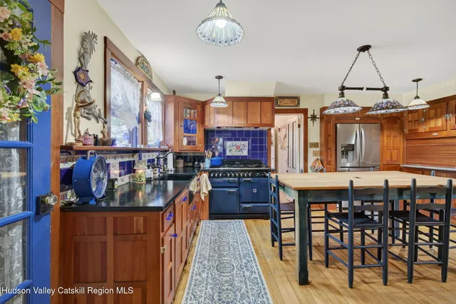 a kitchen with stainless steel appliances granite countertop a stove and cabinets