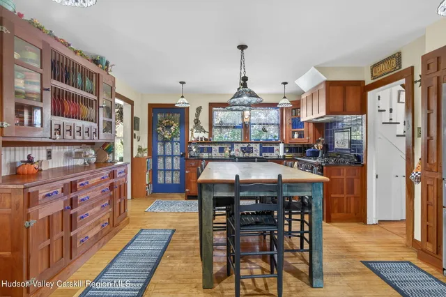 a kitchen with stainless steel appliances granite countertop wooden cabinets a stove and a center island