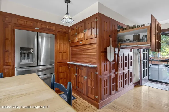 a way to bedroom with wooden floor and windows