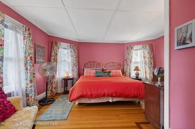 a bedroom with a bed and a mirror