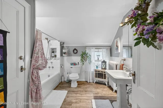 a living room with furniture and flowers