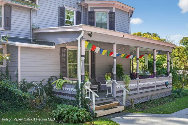 a view of house with outdoor space and porch