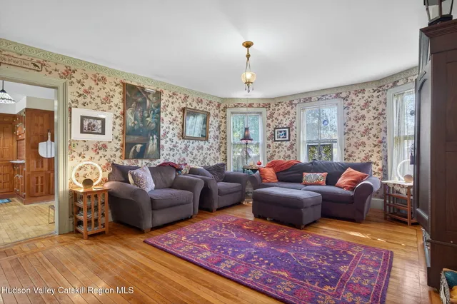 a living room with furniture a lamp and a rug