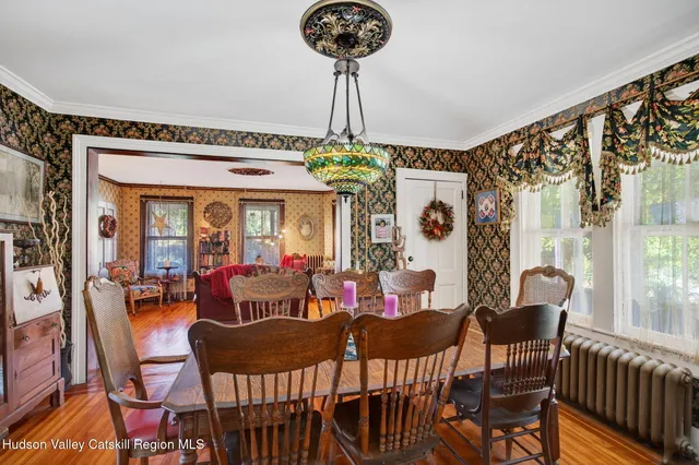 a view of a dining room with furniture wooden floor and chandelier