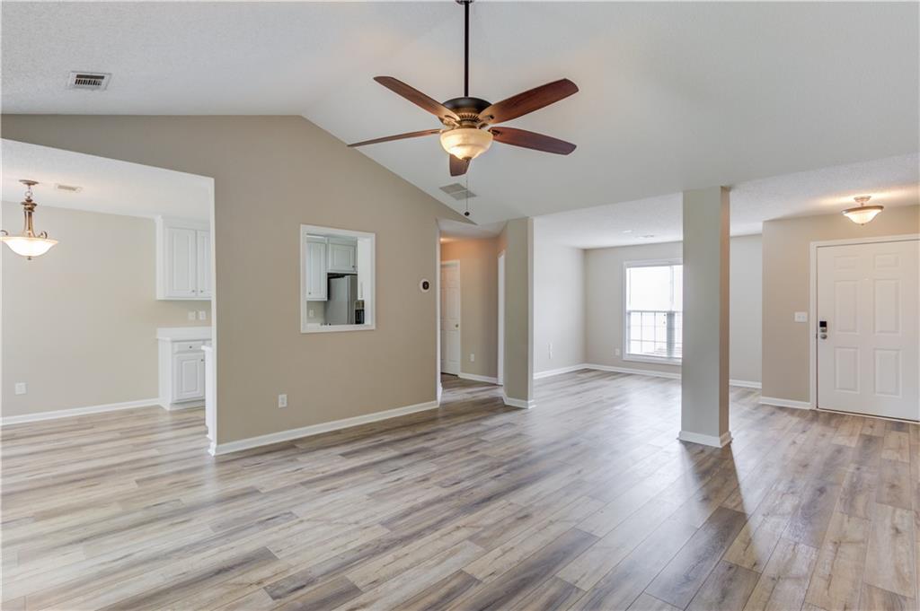 255 Turnberry Lane Winder, GA 30680 - Photo 11 of 41 a view of a livingroom with a ceiling fan and wooden floor