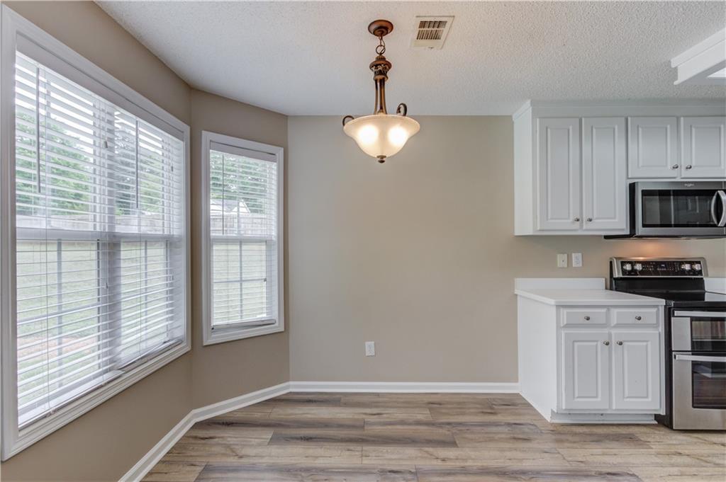 255 Turnberry Lane Winder, GA 30680 - Photo 12 of 41 a view of a kitchen with a sink dishwasher and wooden floor
