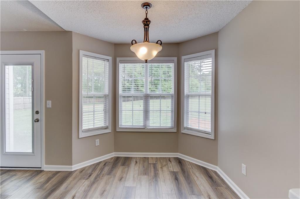 255 Turnberry Lane Winder, GA 30680 - Photo 13 of 41 wooden floor in an empty room with a window