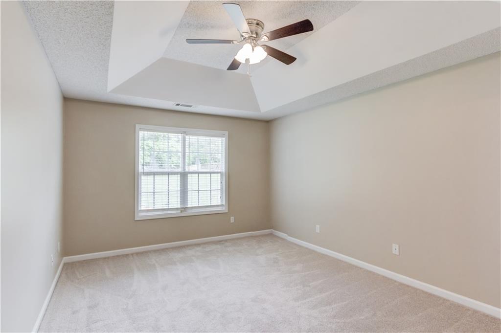 255 Turnberry Lane Winder, GA 30680 - Photo 18 of 41 an empty room with a window and a fan