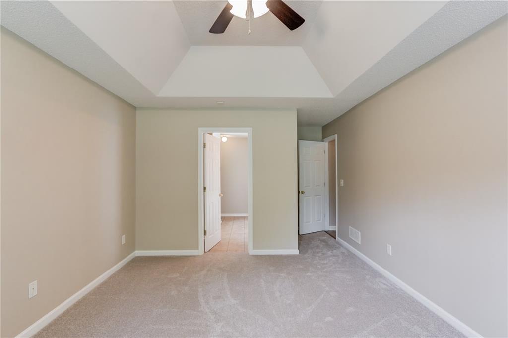 255 Turnberry Lane Winder, GA 30680 - Photo 19 of 41 an empty room with chandelier fan and closet