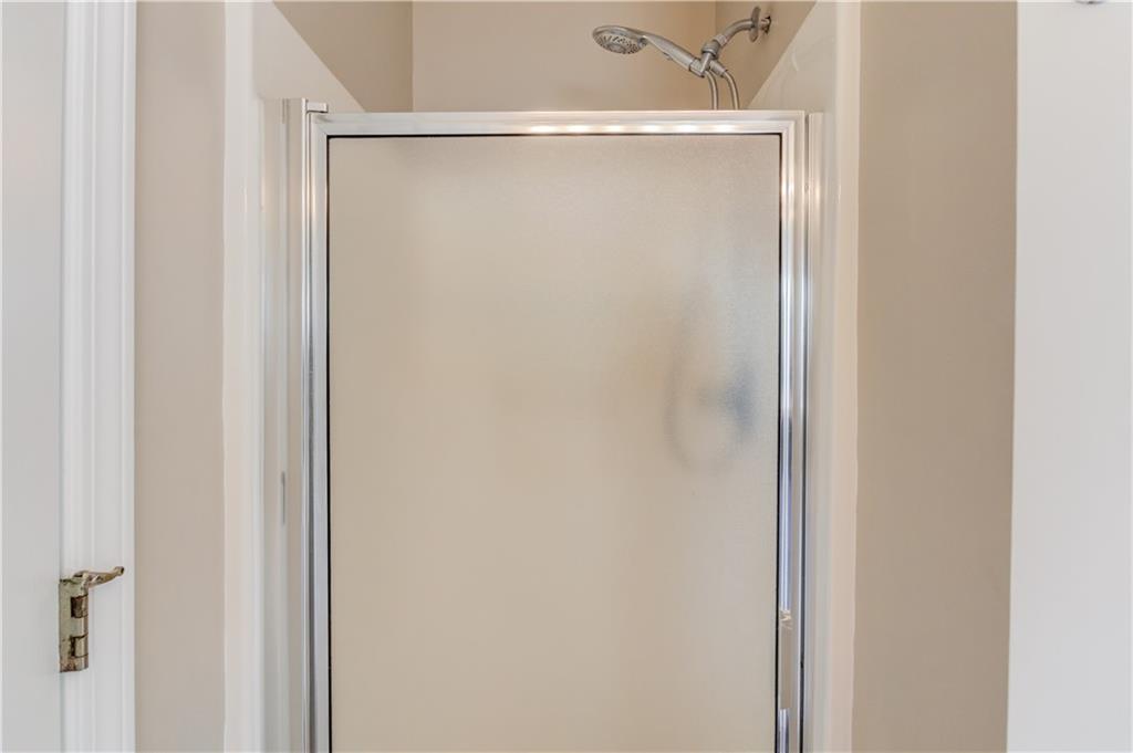 255 Turnberry Lane Winder, GA 30680 - Photo 22 of 41 a bathroom with a glass shower door