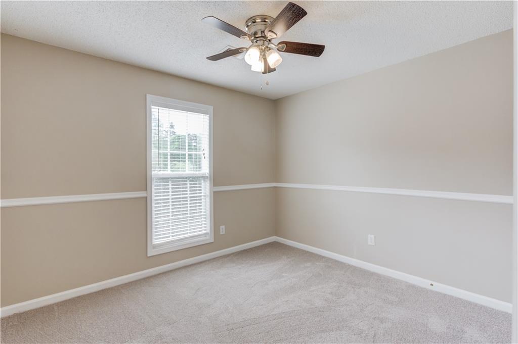 255 Turnberry Lane Winder, GA 30680 - Photo 24 of 41 an empty room with a window and a fan