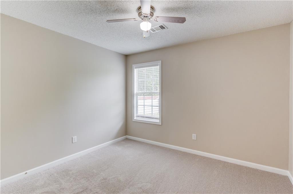 255 Turnberry Lane Winder, GA 30680 - Photo 27 of 41 an empty room with a window and a ceiling fan