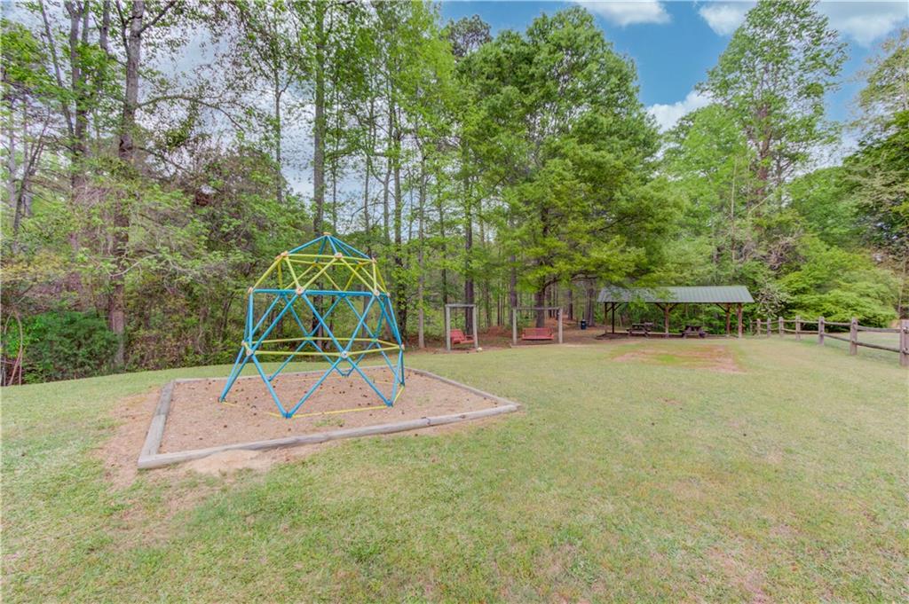 255 Turnberry Lane Winder, GA 30680 - Photo 37 of 41 a park view with a bench and trees