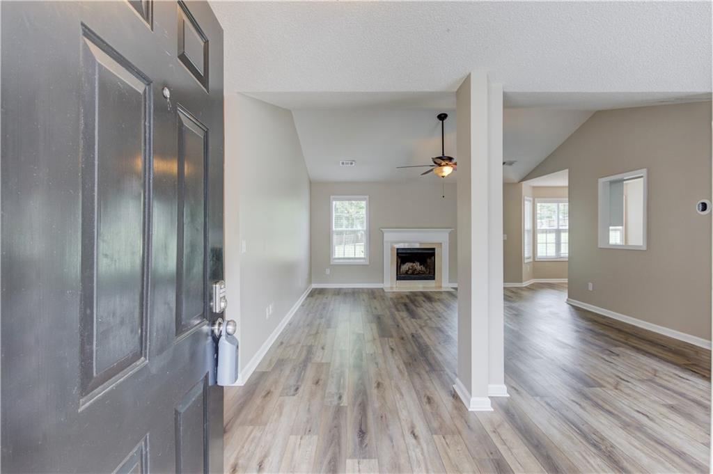 255 Turnberry Lane Winder, GA 30680 - Photo 4 of 41 a view of livingroom with hardwood floor and a fireplace