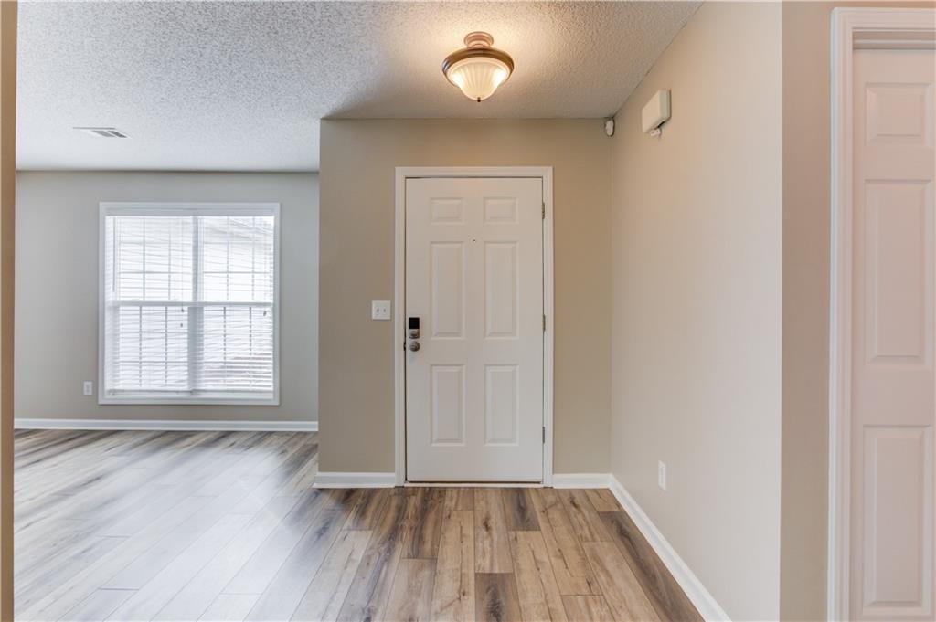 255 Turnberry Lane Winder, GA 30680 - Photo 5 of 41 an empty room with wooden floor and windows