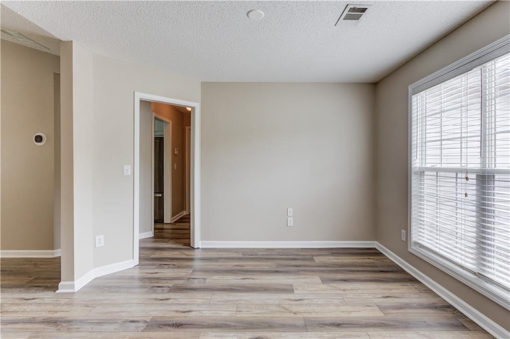255 Turnberry Lane Winder, GA 30680 - Photo 6 of 41 a view of an empty room with wooden floor and a window