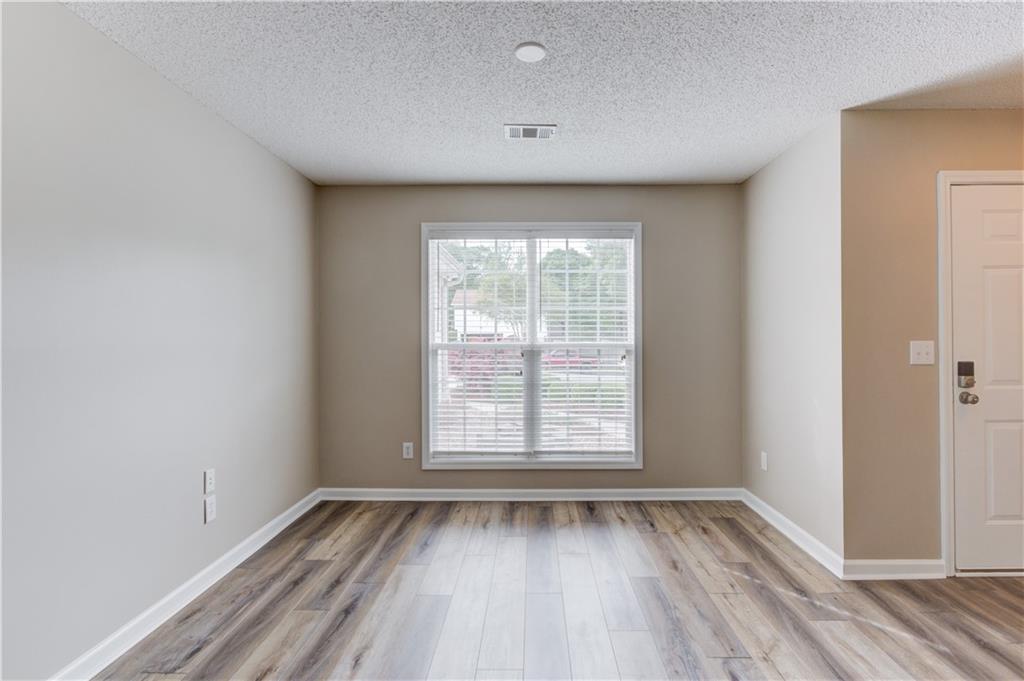 255 Turnberry Lane Winder, GA 30680 - Photo 7 of 41 an empty room with wooden floor and windows