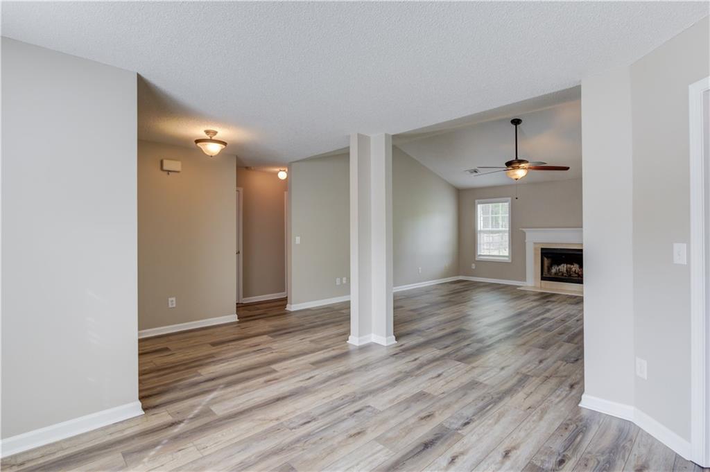 255 Turnberry Lane Winder, GA 30680 - Photo 8 of 41 a view of empty room with wooden floor and fireplace