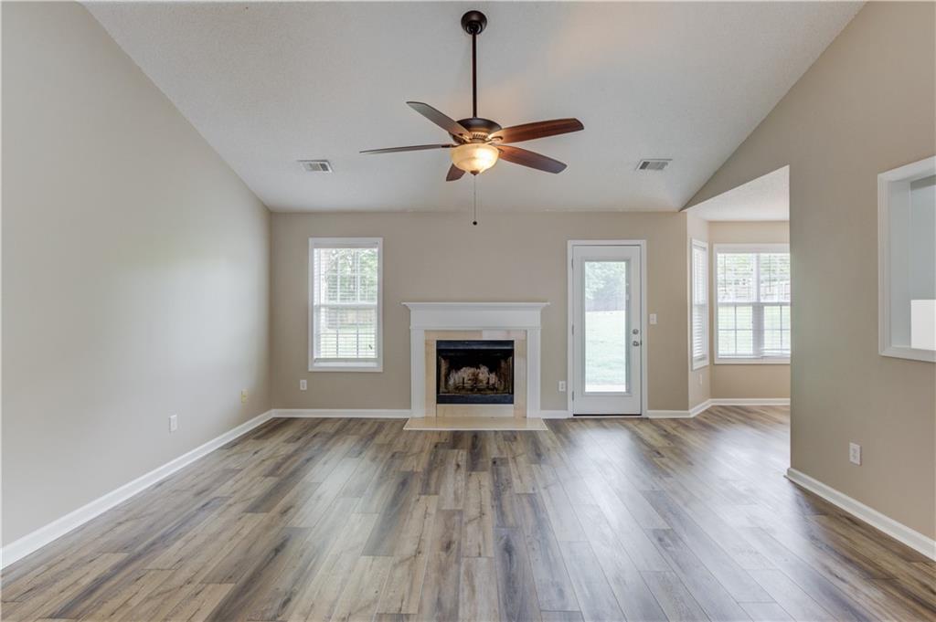 255 Turnberry Lane Winder, GA 30680 - Photo 9 of 41 a view of an empty room with a window and fireplace