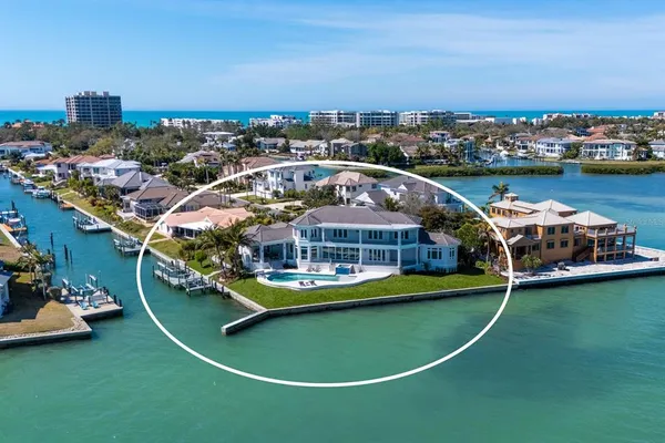 a front view of yellow house with plants and plants