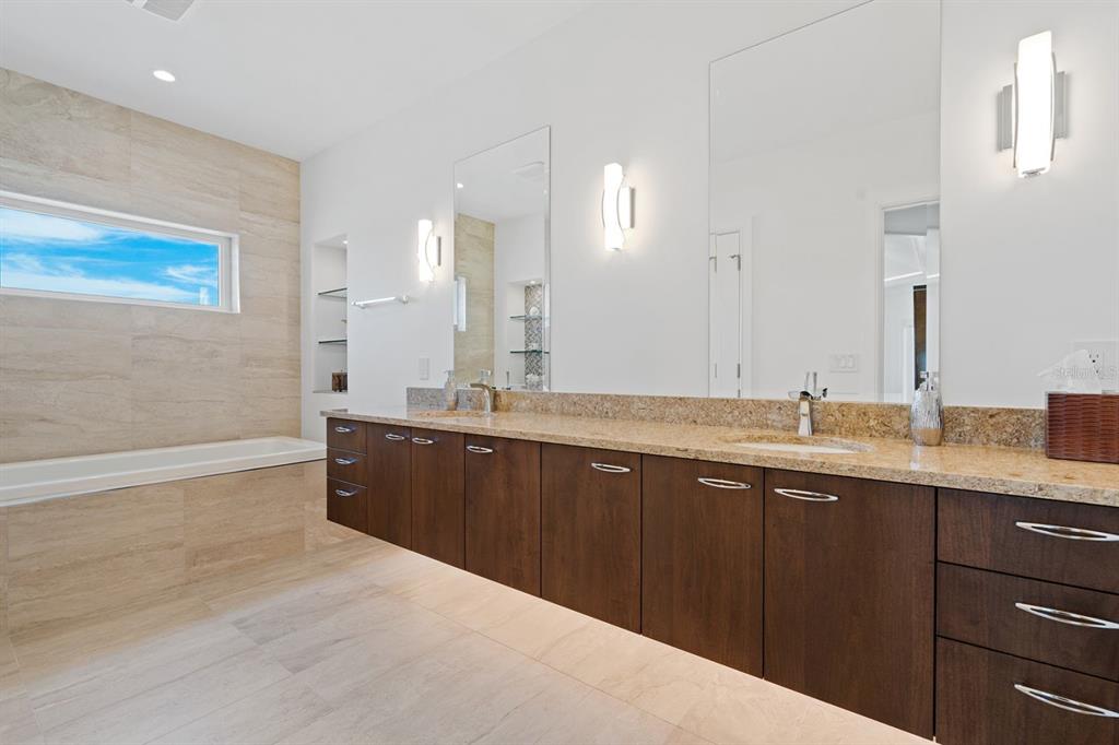 600 Putter Lane Longboat Key, FL 34228 - Photo 19 of 44 a large bathroom with a double vanity sink and a mirror
