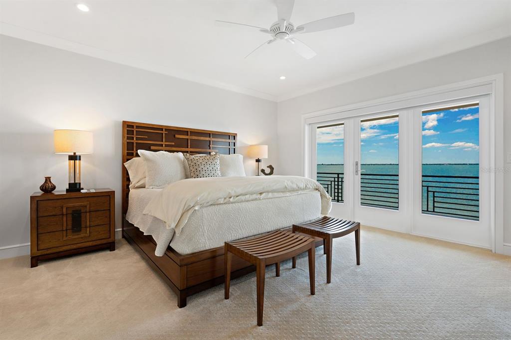 600 Putter Lane Longboat Key, FL 34228 - Photo 20 of 44 a bed room with a bed and a chair