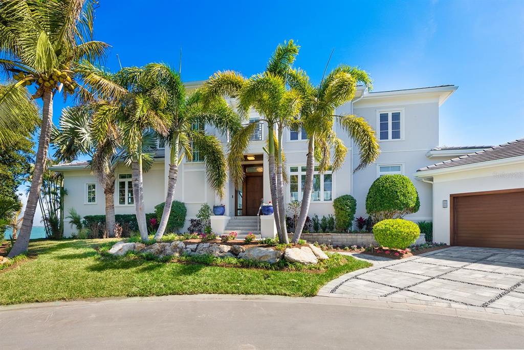 600 Putter Lane Longboat Key, FL 34228 - Photo 2 of 44 a front view of yellow house with plants and plants