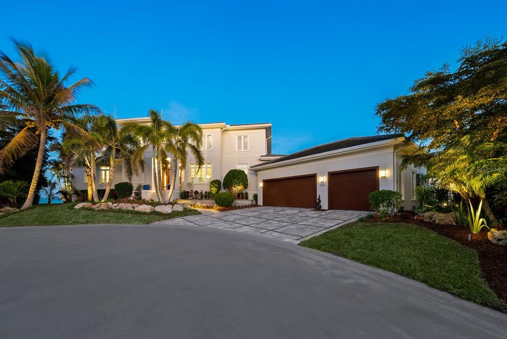 600 Putter Lane Longboat Key, FL 34228 - Photo 29 of 44 a view of a house with a yard and garage