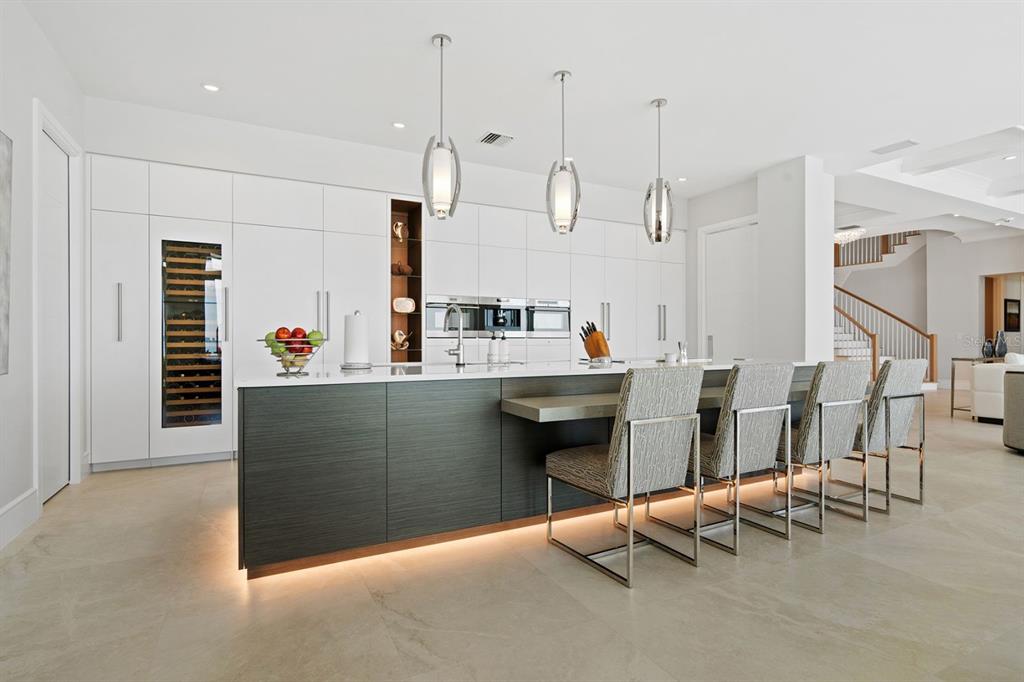 600 Putter Lane Longboat Key, FL 34228 - Photo 5 of 44 a kitchen with stainless steel appliances kitchen island granite countertop a table and chairs in it