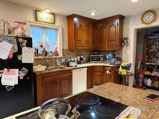 a kitchen with a sink appliances and cabinets