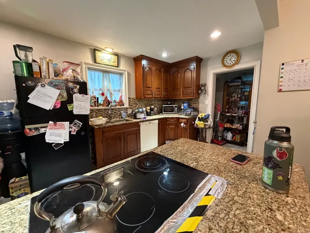 a kitchen with stainless steel appliances granite countertop a stove and a sink