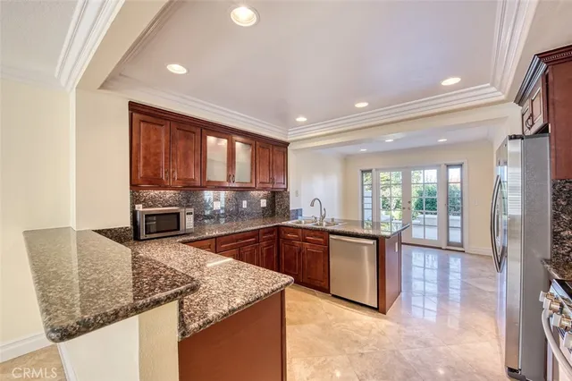 a kitchen with stainless steel appliances granite countertop a sink stove and cabinets