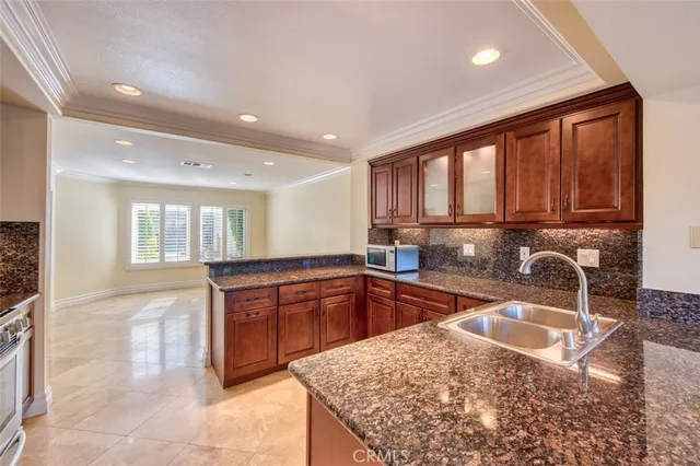 a kitchen with stainless steel appliances a refrigerator and a cabinets